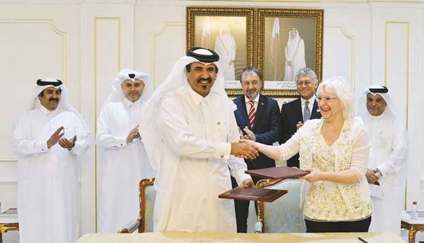 Qatar Chamber first vice chairman Mohamed bin Towar al-Kuwari and Jelena Jovanovic, the director of the Serbian chamberu2019s International Economic Relations Sector, shake hands after signing the MoU. PICTURE: Ram Chand