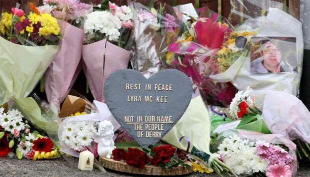 Floral tributes and a plaque condemning the killing of journalist Lyra McKee are seen at the scene of the violence 