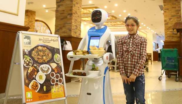 AT YOUR SERVICE: Canaan Gardens in Hyatt Plaza launches robot waitress to serve customers. Photo by Jayan Orma
