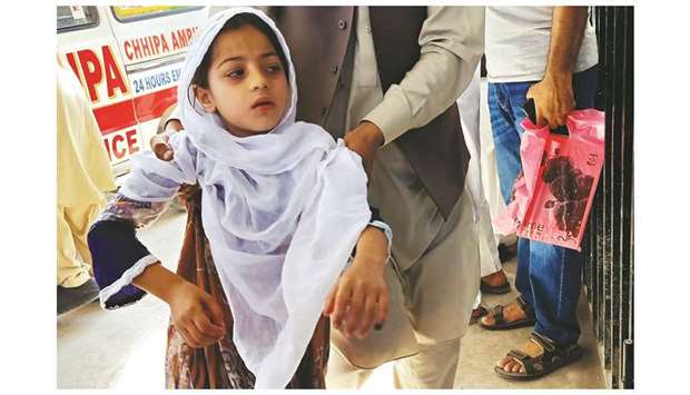 In this picture taken on Monday, a man rushes his daughter to a hospital in Peshawar after she had received a polio vaccination. More than 25,000 children were rushed to hospitals in northwest Pakistan after rumours spread that some had suffered reactions to a polio vaccine, officials said yesterday.