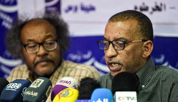 Sudanese civil society activists Muawia Shaddad (L) and Omar el-Digeir (R), two of the leaders from the protest movement led by the Alliance for Freedom and Change, give a press conference in the capital Khartoum