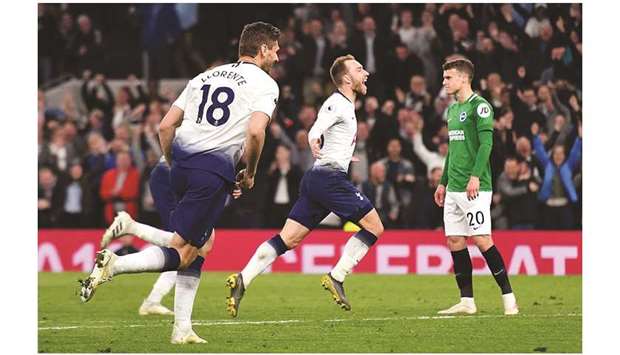 Tottenham Hotspuru2019s Christian Eriksen (centre) celebrates after scoring the winner in the 88th minute during the Premier League match against Brighton. (AFP)