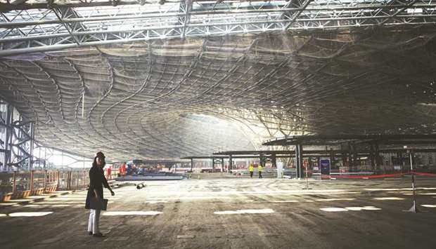 A media person stands inside a terminal building under construction at the new international airport in the Daxing district of Beijing in July 2018. Chinau2019s Civil Aviation Administration is reportedly planning to build an additional 74 airports to make a total of 260 by 2020.