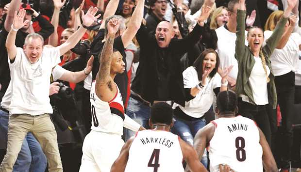 Damian Lillard (second from left) of the Portland Trail Blazers reacts after hitting the game-winning shot in Game Five of the Western Conference quarter-finals against the Oklahoma City Thunder during the 2019 NBA Playoffs in Portland, Oregon, on Tuesday. (AFP)