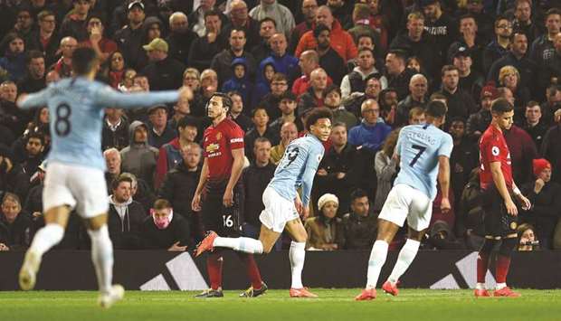 Manchester Cityu2019s Leroy Sane (centre) celebrates after scoring against Manchester United in the Premier League at Old Trafford in Manchester on Wednesday night. (AFP)