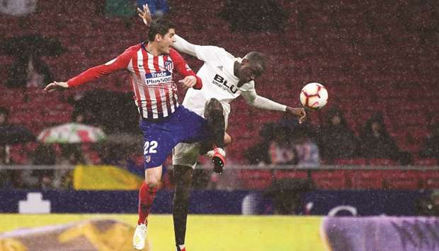 Atletico Madridu2019s Alvaro Morata (left) vies for the ball with Valenciau2019s Mouctar Diakhaby during the La Liga match at the Wanda Metropolitano stadium in Madrid on Wednesday night. (AFP)