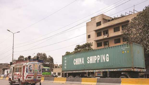 A truck transports a container along the port road in Karachi. u201cThe government has enhanced regulatory duty on finished products and as a result of which the imports have witnessed reduction of $3.5bn over the past 9-10 months,u201d Adviser to Prime Minister on Commerce Razak Dawood informed the lower house of parliament.