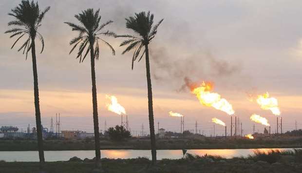 Flames emerge from flare stacks at the oil fields in Basra (file). Investment in Iraqu2019s oil and gas sector has subsided from a peak of just over $20bn in 2014 to about $12bn a year currently, the IEA said.