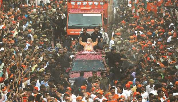 Prime Minister Narendra Modi waves towards his supporters during a roadshow in Varanasi yesterday.