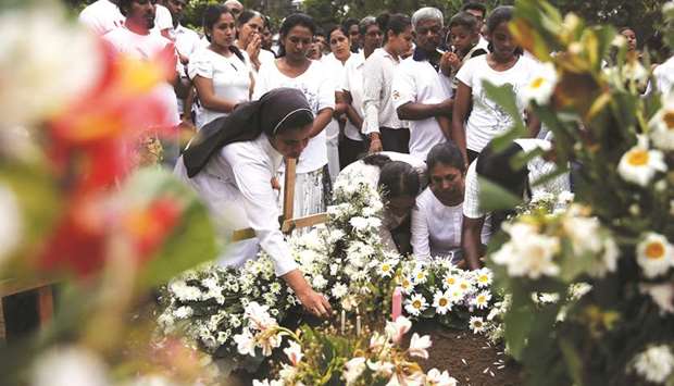 People attend the funeral of Dhami Brindya, 13, a victim of suicide bomb attacks on Easter Sunday, in Negombo, Sri Lanka.