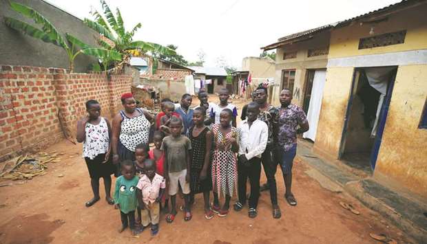 Mariam Nabatanzi, 39, (red hair) takes a family portrait with some of her children at their home in Kasawo village, east of Kampala.