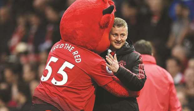 Manchester Unitedu2019s Norwegian manager Ole Gunnar Solskjaer (R) is greeted by the teamu2019s mascot during his teamu2019s  match against Manchester City on April 24.