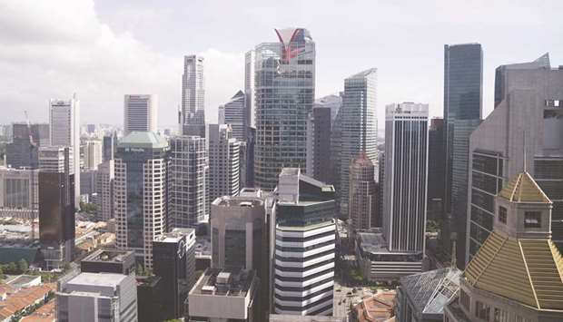 Commercial and residential buildings in the central business district in Singapore. The Southeast Asian nation is encouraging major foreign-exchange players to build systems in the country that would remove the sub-second delay caused by routing trades via Tokyo or London.