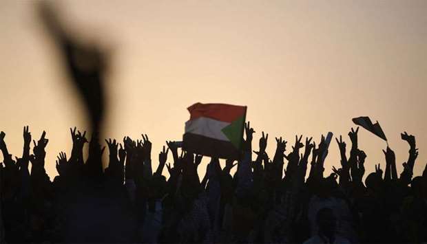 Sudanese protesters chant slogans as they gather for a ,million-strong, march outside the army headquarters in the capital Khartoum