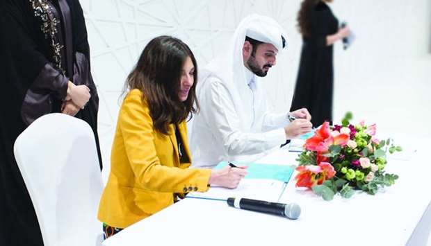 Dignitaries from QBIC and FTA signing the agreement during the Heya Arabian Fashion Exhibition.