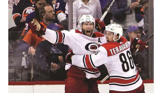 Jordan Staal of the Carolina Hurricanes celebrates with with Teuvo Teravainen after scoring an overtime goal against the New York Islanders in Game One of the Eastern Conference Second Round during the 2019 NHL Stanley Cup Playoffs at the Barclays Center in New York. (Getty Images/AFP)