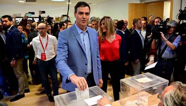 Spanish Prime Minister and Spanish Socialist Party (PSOE) candidate for prime minister Pedro Sanchez casts his ballot next to his wife Begona Gomez at a polling station in Madrid during general elections in Spain