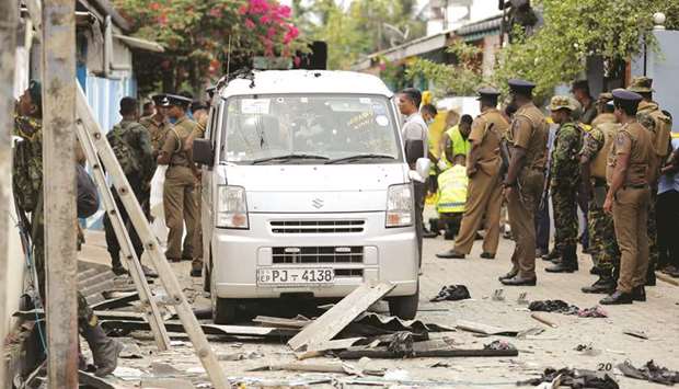 Security personnel seen at the site of an overnight gun battle, between troops and suspected militants, on the east coast of Sri Lanka, in Kalmunai yesterday.