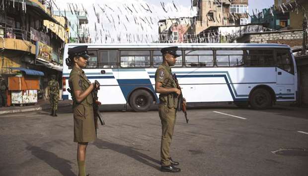 Police stand guard at a barricade near St Anthonyu2019s Shrine yesterday, a week after a series of bomb blasts targeting churches and luxury hotels on Easter Sunday in Sri Lanka.