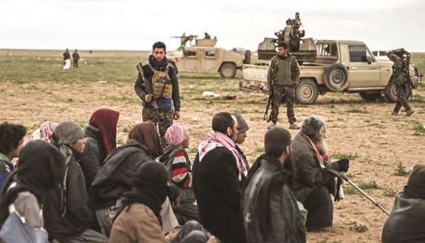 Men suspected of being Islamic State (IS) militants wait to be searched by members of the Kurdish-led Syrian Democratic Forces (SDF) after leaving the IS groupu2019s last holdout of Baghouz, in the northern Deir Ezzor province. February 27, 2019 file picture.