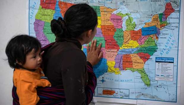 A Guatemalan woman looks at a map of the United States at the Casa del Refugiado, or The House of Refugee, a new centre opened by the Annunciation House to help the large flow of migrants being released by the United States Border Patrol and Immigration and Customs Enforcement in El Paso, Texas