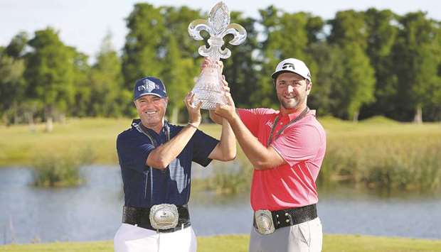 Jon Rahm of Spain and Ryan Palmer of the United States pose with the trophy after winning the final round of the Zurich Classic at TPC Louisiana in Avondale, Louisiana. (Getty Images/AFP)