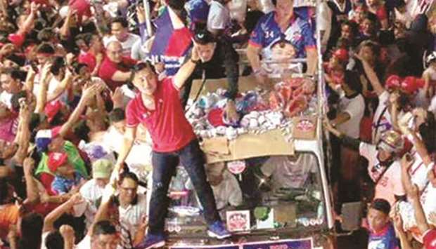 Supporters of Senate aspirant Christopher Lawrence u2018Bongu2019 Go crowd around his caravan in Paranaque City.