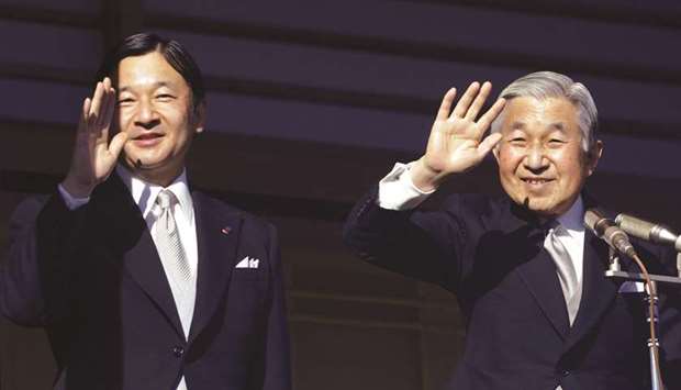 Japanese Emperor Akihito (right) and Crown Prince Naruhito wave to well wishers at the Imperial Palace in Tokyo.