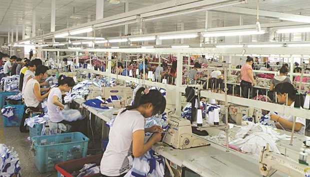 Employees work at a garment factory in Shanghai. Chinau2019s factory activity likely expanded at a steady but modest clip in April, marking the second straight month of improving business conditions, as government growth-boosting measures buoy the vast manufacturing sector.