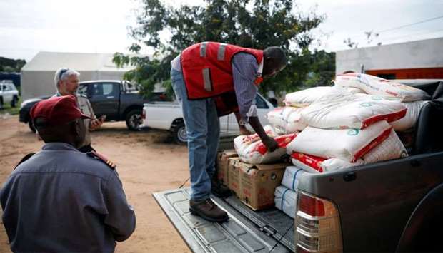Aid workers load food onto a truck as flooding spreads in the aftermath of Cyclone Kenneth in Pemba, Mozambique
