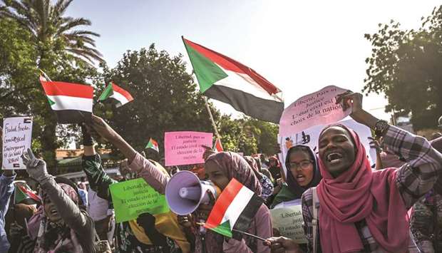Sudanese foreign language students march during a sit-in outside the army headquarters in the capital Khartoum, yesterday.