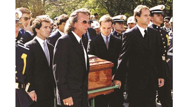Former Formula One racing champions carry Ayrton Sennau2019s coffin to his grave during the funeral service in Brazil on May 5, 1994. From left to right Alain Prost, Emerson Fittipaldi, Rubens Barichelo and Gerhard Berger. At bottom, Senna (L) with McLaren manager Ron Dennis after winning the 1993 Monaco Grand Prix on May 23, 1993. (File photos)