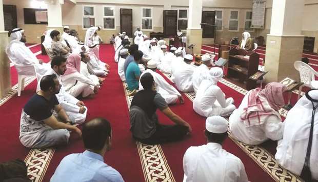 The faithful attending a religious lecture in a mosque.