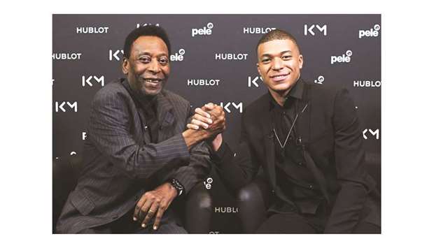 PSG and France forward Kylian Mbappe (right) and Brazilian football legend Pele shake hands during their meeting in Paris on Tuesday. (AFP)