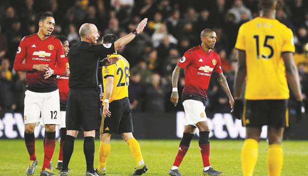 Manchester Unitedu2019s Ashley Young (second right) is sent off by referee Mike Dean during the Premier League match against Wolverhampton Wanderers. (Reuters)