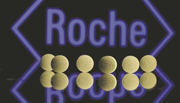 Roche tablets are seen positioned in front of a displayed Roche logo in this illustration. The company said its effort to expand in gene therapy via the $4.3bn takeover of Spark  Therapeutics remained on track despite failing to get enough votes to clinch the deal and as US regulators continued scrutinising it.