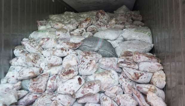 Sacks of pangolin scales mixed with packs of frozen meat in a container van in Singapore.