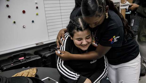 COMFORT: Jaleyah Collier hugs her friend Chelsea Reyes, 17, as they spend time together after school at Hawkins High School in Los Angeles, California.