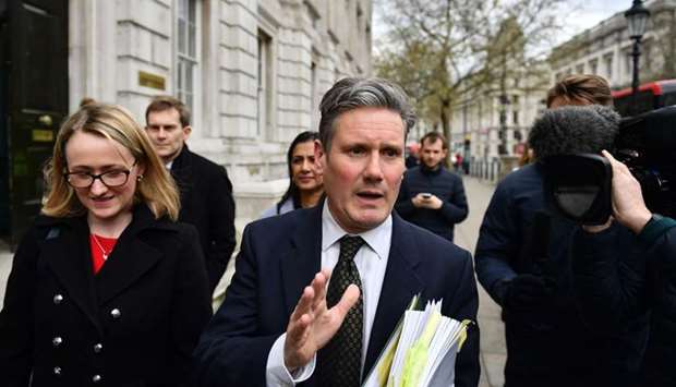 Labour's Brexit spokesman Keir Starmer speaks to journalists as he leaves the Cabinet office in central London on April 4.