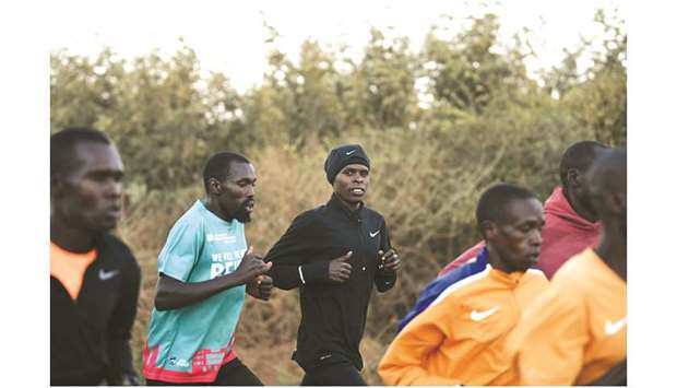In this March 14, 2019, picture, long-distance runner Paul Lonyangata (centre) takes part in a training session in Kaptagat, a training camp in the Kenyan mountains. (AFP)