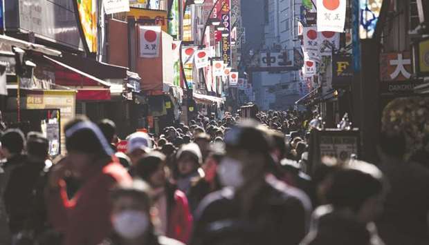 Pedestrians walk through Ameyoko market in Tokyo. Japanu2019s household spending rose 1.7% year-on-year in February, data showed yesterday.