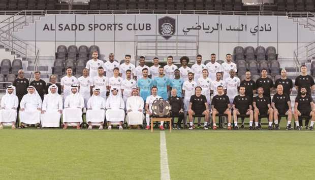 Al Sadd squad, coach Jesualdo Ferreira and the club officials pose with the Falcon Shield a day after winning the QNB Stars League title.