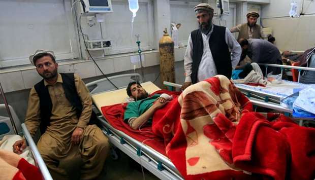 An injured man receives treatment in a hospital, after twin explosions in Jalalabad, Afghanistan.