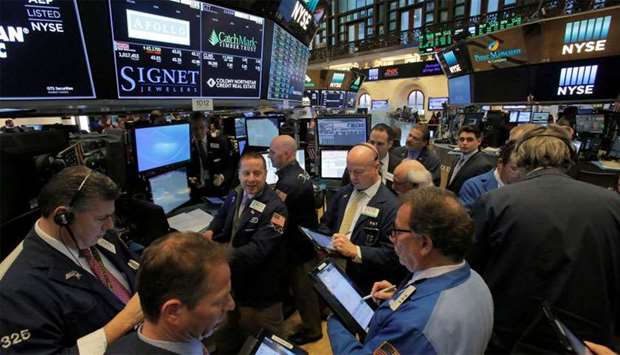 Traders work on the trading floor at the New York Stock Exchange in Manhattan