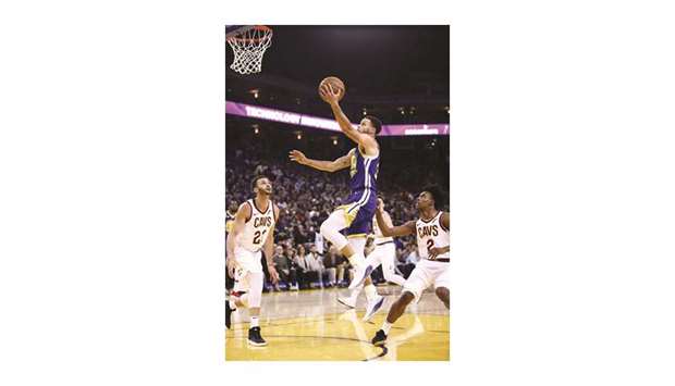 Stephen Curry (centre) of the Golden State Warriors goes up for a shot during the game against Cleveland Cavaliers in Oakland, California, on Friday. (AFP)