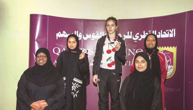 Winner Elizaveth Shakhova (centre), second-placed Haya Mohamed al-Boloushi (rear, left) and third-placed Matara Fahad al-Assieri (rear, right) pose on the podium for womenu2019s 50m Rifle 3 Positions at Amir Cup Shooting and Archery Championships at the Losail Shooting Ranges yesterday.