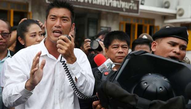Thanathorn Juangroongruangkit, leader of the Future Forward Party speaks to his supporters as he arrives at a police station to hear a sedition complaint filed by the army in Bangkok, Thailand