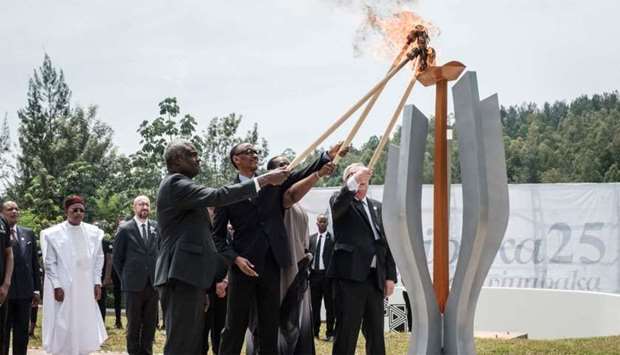 (From L) African Union chief Moussa Faki, Rwanda's President Paul Kagame, his wife Jeannette (2ndR), and European Commission President Jean-Claude Juncker light a remembrance flame for the 25th Commemoration of the 1994 Genocide at the Kigali Genocide Memorial in Kigali, Rwanda