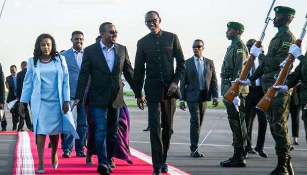 Rwanda's President Paul Kagame (R) welcomes Ethiopia's Prime Minister Abiy Ahmed who will attend for the 25th Commemoration of the 1994 Genocide against the Tutsi, yesterday at Kigali international airport in Kigali, Rwanda