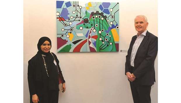 ARTWORK: Jamila al-Shraim, a Qatari artist, with Richard Ou2019Kennedy pose in front of Jamilau2019s artwork.